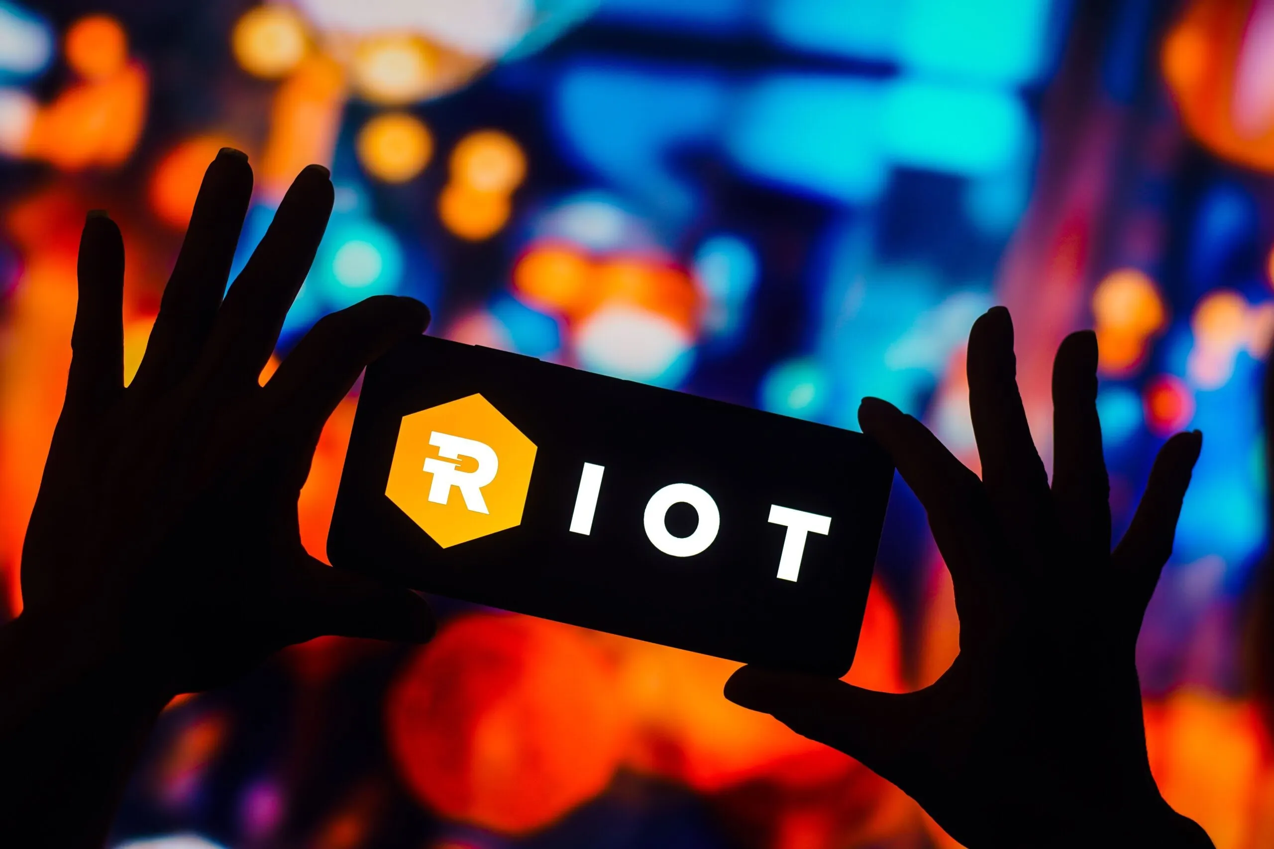 Bitcoin miner Riot Platforms logo on a smart phone. Source: Shutterstock